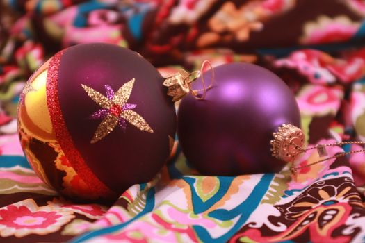 Colorful purple metallic Christmas ornaments for the holidays. Christmas tree decorations for the season.