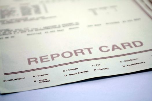Report card form for student. Grades and evaluations for high school or college student. Report card document on background.