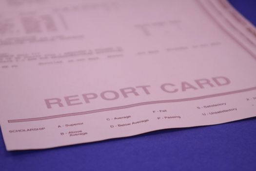 Report card form for student. Grades and evaluations for high school or college student. Report card document on background.