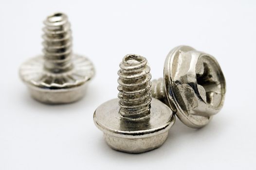 three metal screws, distance blur, macro photo