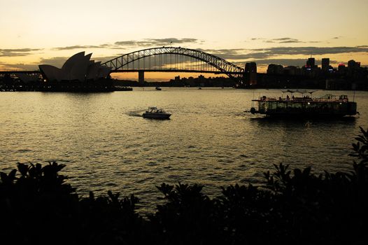 opera house and harbour bridge, boats in foreground, dusk