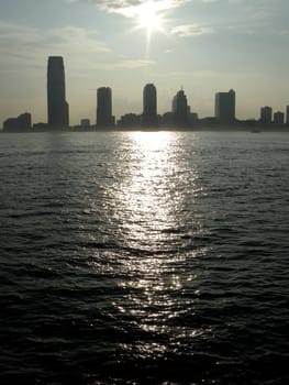 Jersey City office buildings silhouettes, photo taken across Hudson River from Manhattan, New York
