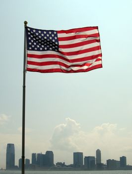 USA flag waving in front of Jersey City
