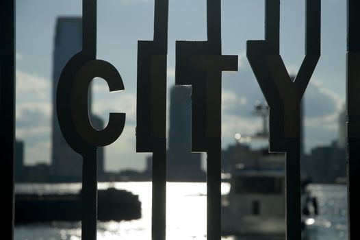CITY sign ... photo taken in manhattan, near world business center. defocused buildings in background are from jersey city.