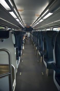 train interior with almost no people, mostly grey color