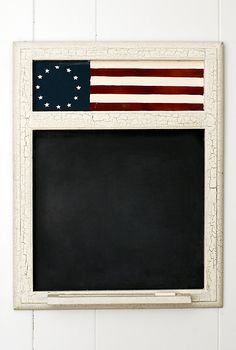 small blackboard with usa flag on it, some unreadable writing 