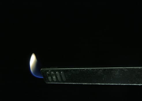 kitchen gas lighter detail photo, black background