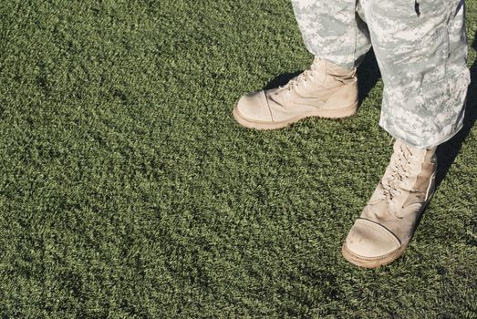 Soldier in camouflage pants and army boots.