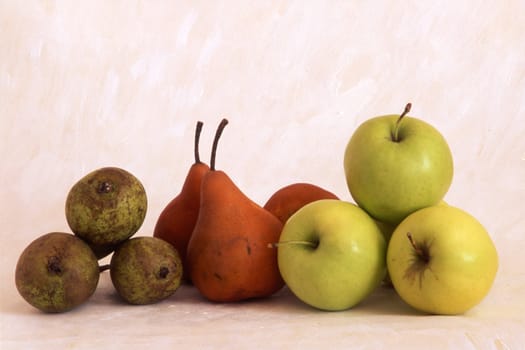 Pears and apples isoated on painted background