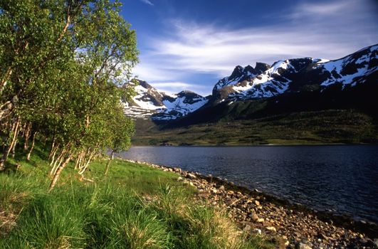 Snow mountain and lake in Norway in summer