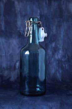 A empty bottle isolated on blue background