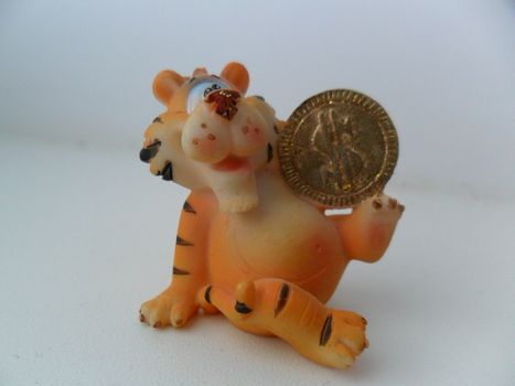 Hand-made article from day as a tiger cub with a coin