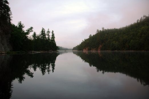 Fisherman on a lake at sunset