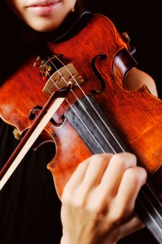 Musician playing violin. Isolated on the black background