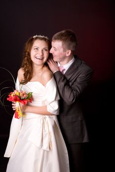 Portrait of Happy New Married couple over dark background