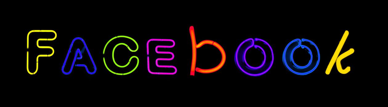 Facebook written with neon letters  on black background