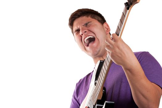 A man in his late teens rocks out while playing his electric guitar.