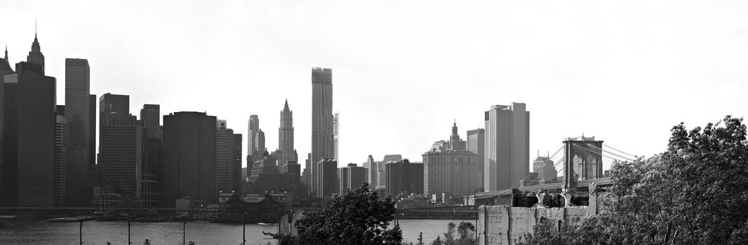 A panoramic image of the New York City Manhattan skyline including the Brooklyn bridge  bridge.