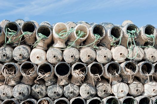 A stack of industrial aquaculture equipment in a harbour