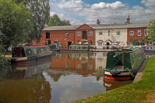 The Trent and Mersey canal at Fradley Junction in Staffordshire, England. In contrast with days gone by the boats are now almost entirely used for pleasure.