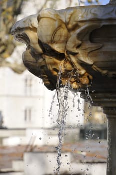 Detail of a stone fountain with water rooted to the spot