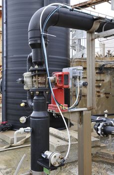 Industrial black plastic tank and control system with some branchs and pumps