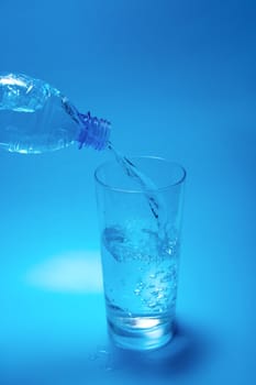 Pouring water from a plastic bottle