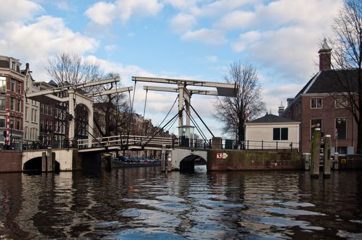 Typical wooden drawbridge over a canal in Amsterdam, Netherlands