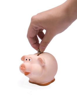 Hand inserting coin into piggy bank isolated on white