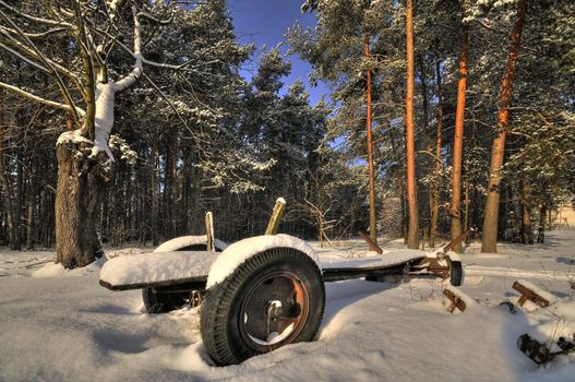 Abandoned cart covred with snow in winter