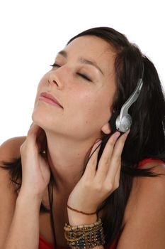 Beautiful young lady listening to music on ear phones