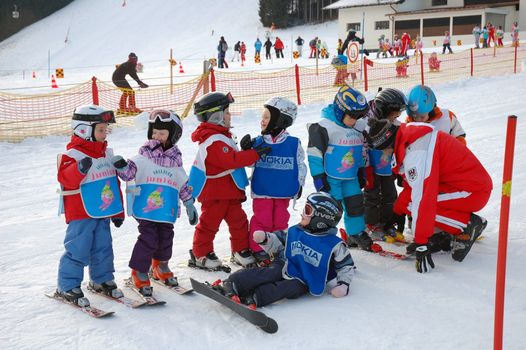 ZELL AM SEE, AUSTRIA - DECEMBER 22: 3-5 year old children at Ski school in Zell am See, Austria. Austrian ski schools are famous for the training plans, that guarantees the safety of about 10 million ski drivers on austrian ski areas per year.