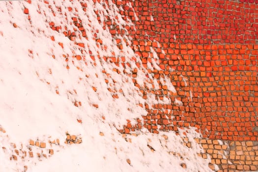 Old colored mosaics partially covered with snow