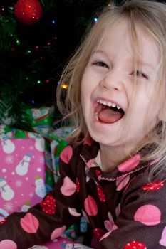 A happy little girl who is very excited to open her presents!