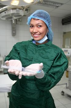 asian nurse showing syringes