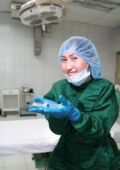 operating room nurse showing syringe