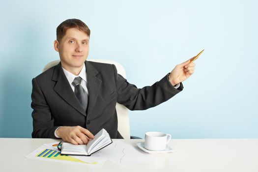 A young businessman shows the direction of using the pen