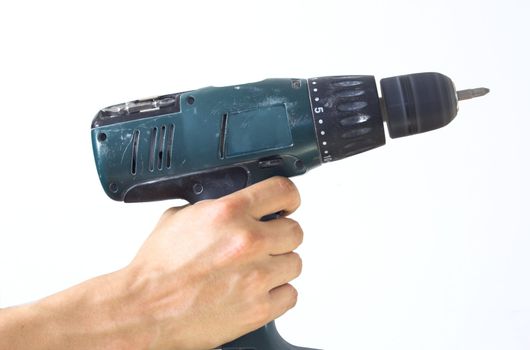 Hand holding cordless drill over white background