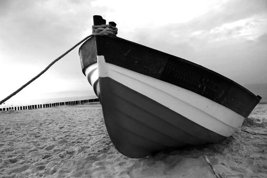 Old fishboat on sandy beach. Beautiful sunset - Baltic Sea in Poland
