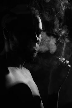 Smoker silhouette over black background