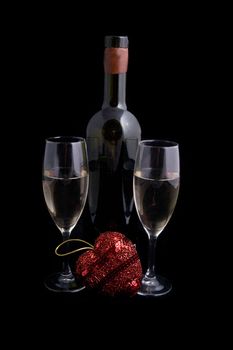 White wine bottle and glasses with red heart over black