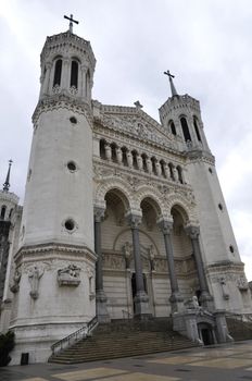 Front of Fourviere cathedral in Lyon city with a cloudy sky