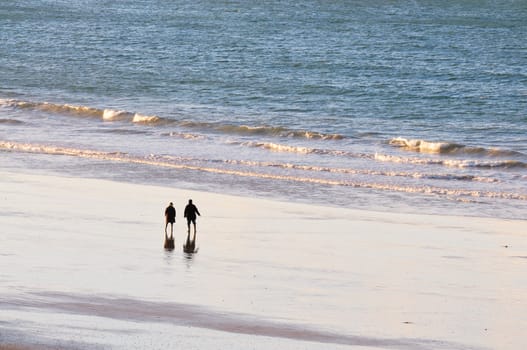 Shot of adult couple watching the ocean on the beach of Saint-Malo in brittany, france