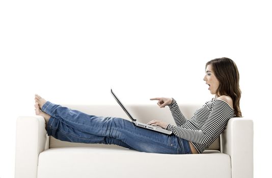 Beautiful woman on a white sofa with a laptop