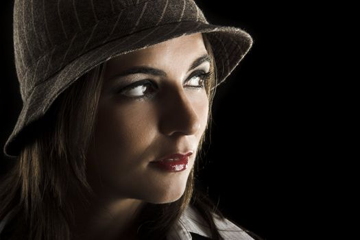 Young woman portrait with hat on a black background

