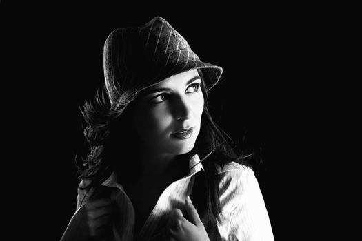 Young woman portrait with hat on a black background

