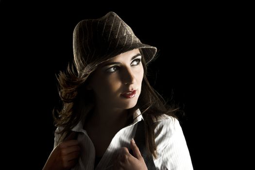 Young woman portrait with hat on a black background

