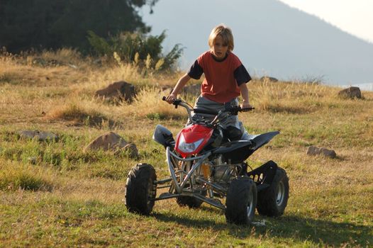 young boy riding ATV for fun
