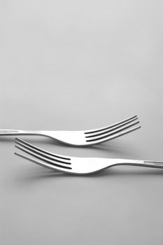 silver forks on light background