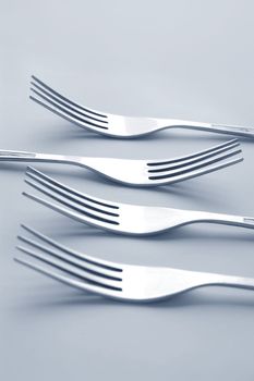 silver forks on light background